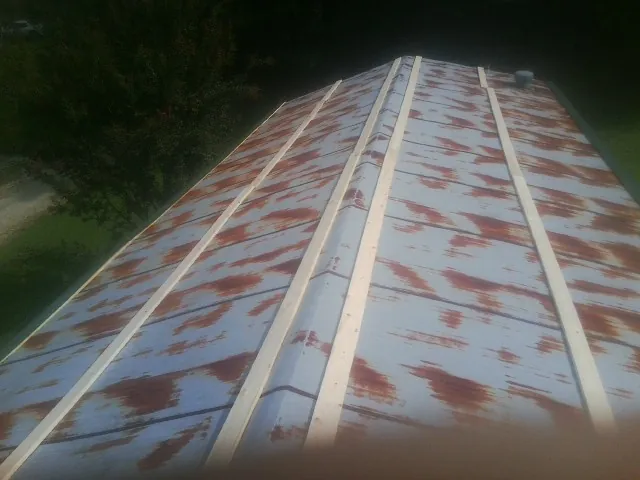 Rusted metal roof panels with new wood purlins before replacement — Storm Damage Roof Repair in Wallace by Roofing Brothers